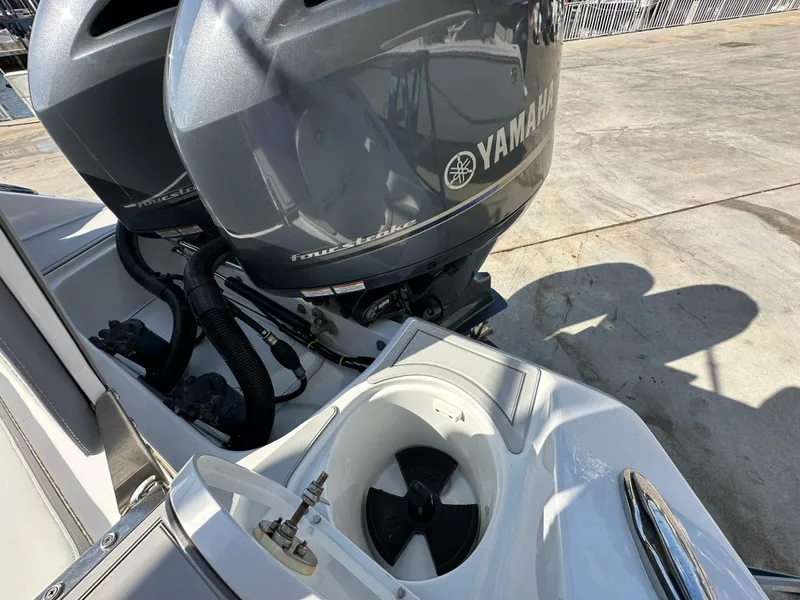 Slide: The Image of Twin Yamaha outboard motors on a 2021 Release 240 RX boat, dockside view. - 7
