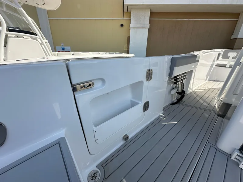 Slide: The Image of 2021 Release 240 RX boat interior with storage compartments and sleek design. - 9