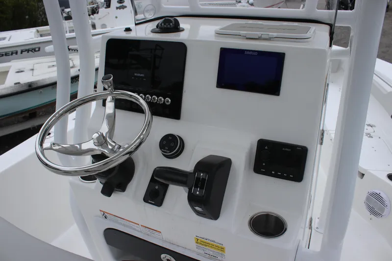 Slide: The Image of 2025 Sea Pro 202 CC boat dashboard with steering wheel and control panel. - 12