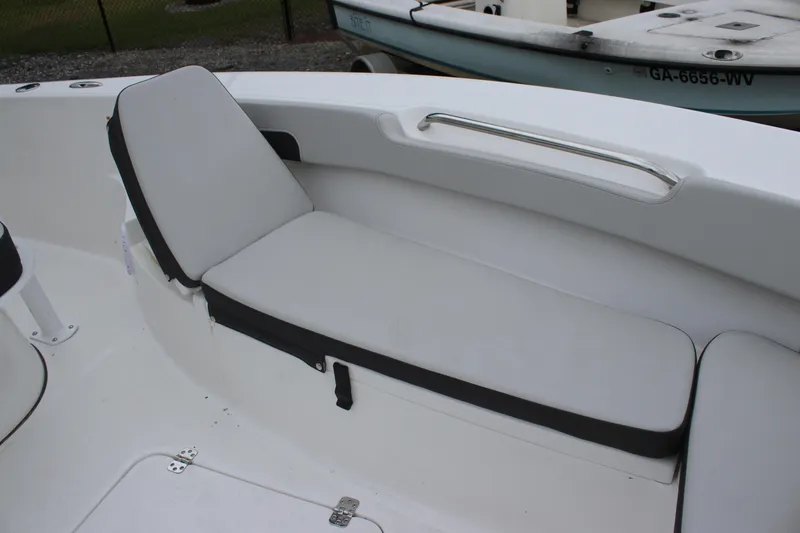 Slide: The Image of 2025 Sea Pro 202 CC boat interior with cushioned seating and sleek design. - 18