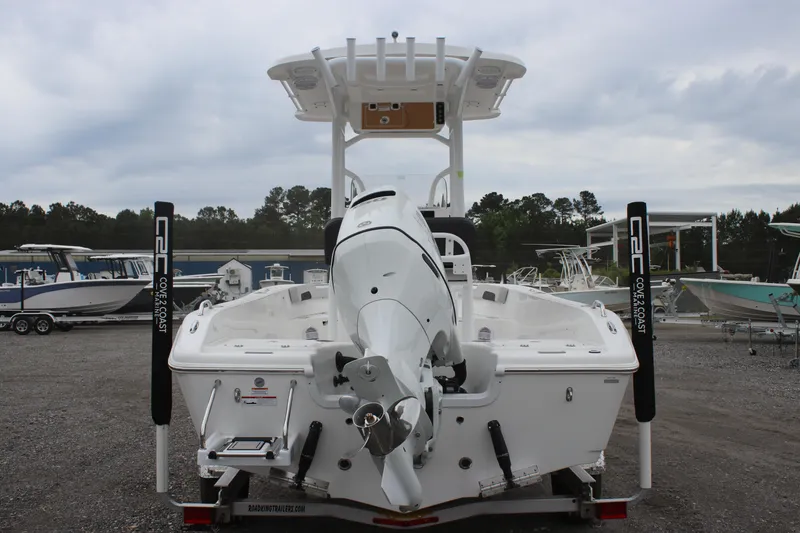 Slide: The Image of 2025 Sea Pro 202 CC boat, rear view, parked on gravel lot. - 3