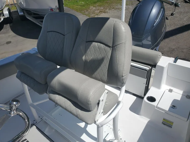 Slide: The Image of 2022 Sportsman Open 212 Center Console boat seats, gray upholstery, dual seating arrangement. - 11