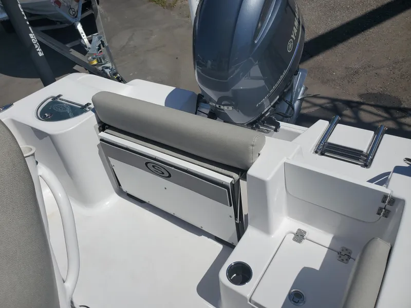 Slide: The Image of 2022 Sportsman Open 212 Center Console boat interior with Yamaha engine, seating, and storage. - 13