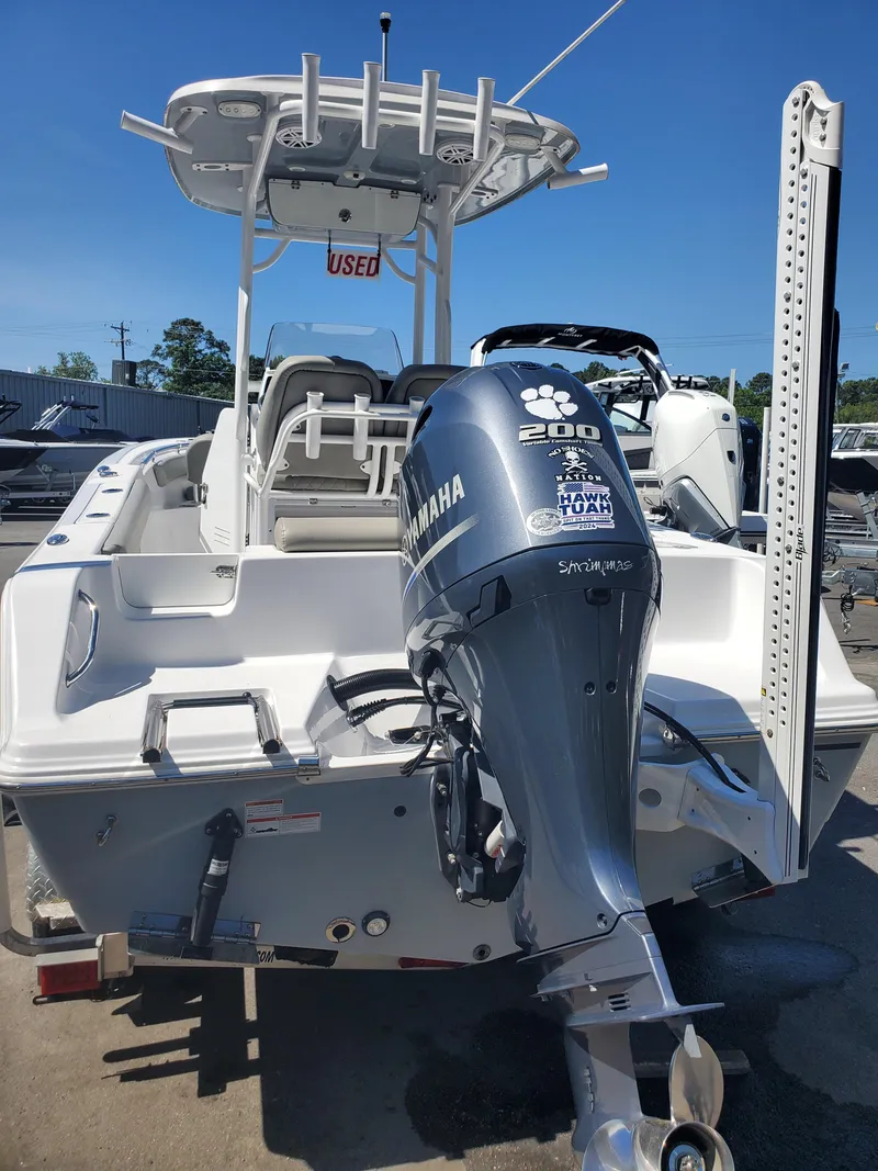 Slide: The Image of 2022 Sportsman Open 212 Center Console boat with Yamaha engine, displayed outdoors. - 14