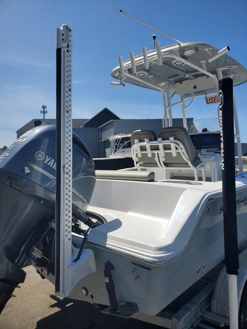 Slide: The Image of 2022 Sportsman Open 212 Center Console boat with Yamaha engine, docked under clear blue sky. - 15