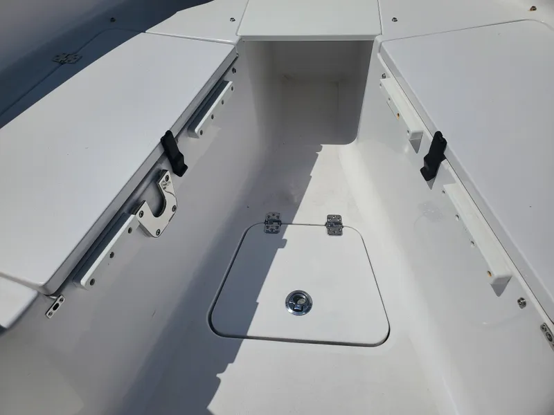 Slide: The Image of 2022 Sportsman Open 212 Center Console boat interior with storage compartments. - 3