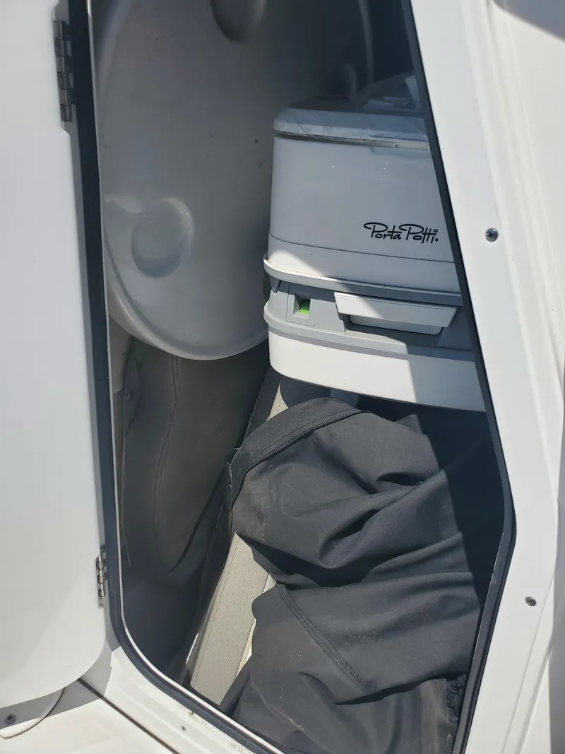 Slide: The Image of 2022 Sportsman Open 212 Center Console storage with Porta Potti and gear. - 6