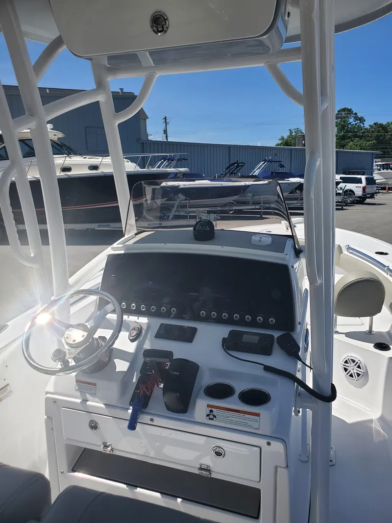 Slide: The Image of 2022 Sportsman Open 212 Center Console boat interior with steering wheel and control panel. - 8