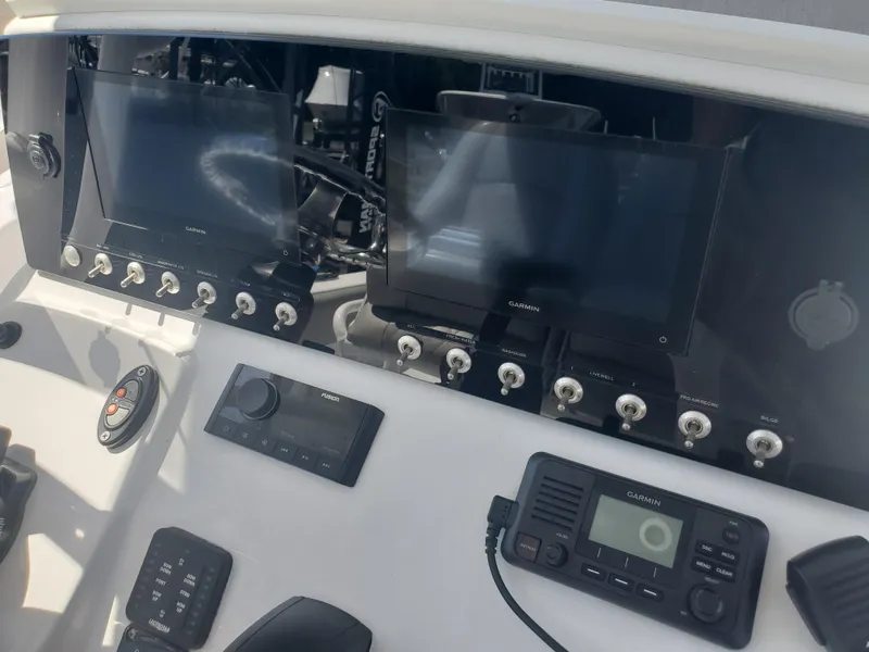 Slide: The Image of Control panel of 2022 Sportsman Open 212 Center Console with navigation screens and radio equipment. - 9