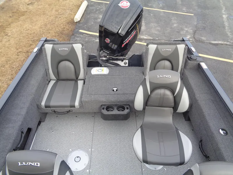 Slide: The Image of 2025 Lund 1775 Adventure SS boat interior with seating and motor. - 11