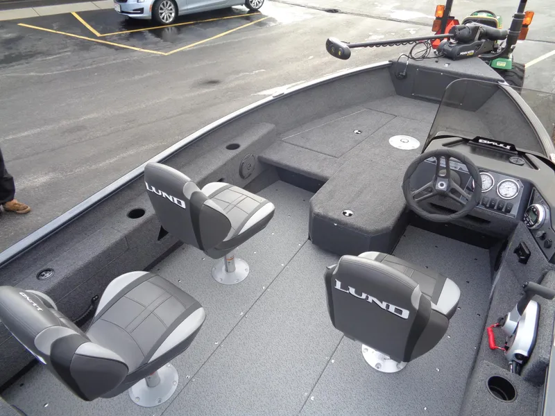 Slide: The Image of 2025 Lund 1775 Adventure SS boat interior with seating and steering console. - 15