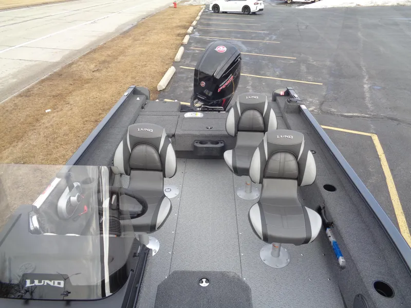 Slide: The Image of 2025 Lund 1775 Adventure SS boat interior with four seats and outboard motor. - 16