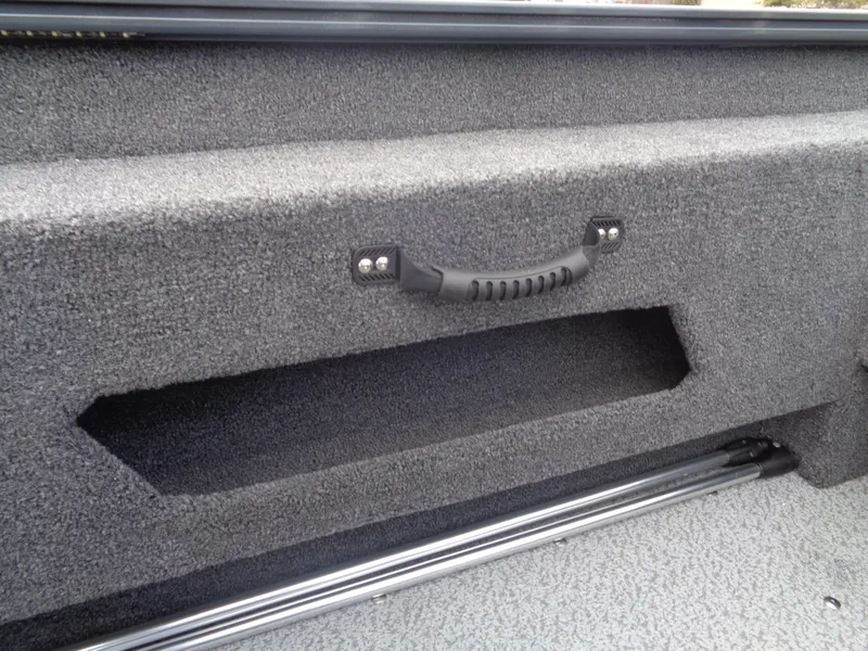 Slide: The Image of 2025 Lund 1775 Adventure SS boat interior storage compartment with handle and textured finish. - 21