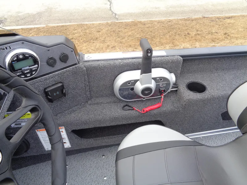 Slide: The Image of 2025 Lund 1775 Adventure SS boat interior with steering wheel and control panel. - 27