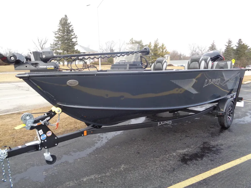 Slide: The Image of 2025 Lund 1775 Adventure SS boat on trailer, parked outdoors, side view. - 4
