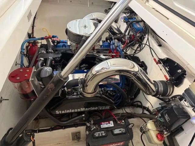 Slide: The Image of Engine compartment of a 2000 Fountain 27 Fever boat, featuring a powerful marine engine. - 10