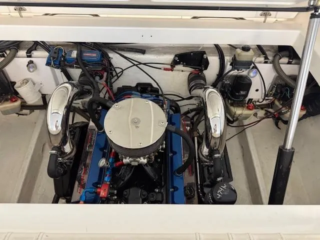 Slide: The Image of Engine compartment of a 2000 Fountain 27 Fever boat, showcasing detailed mechanical components. - 11