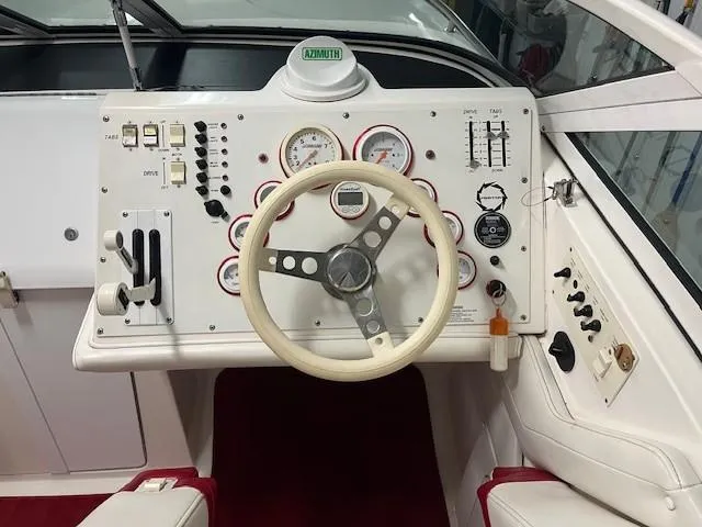 Slide: The Image of Steering wheel and dashboard of a 2000 Fountain 27 Fever boat, featuring gauges and controls. - 3