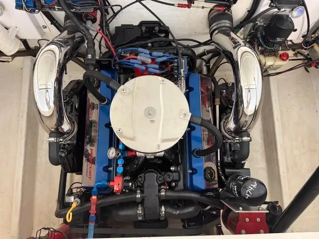 Slide: The Image of Engine of a 2000 Fountain 27 Fever boat, featuring chrome exhausts and blue accents. - 9