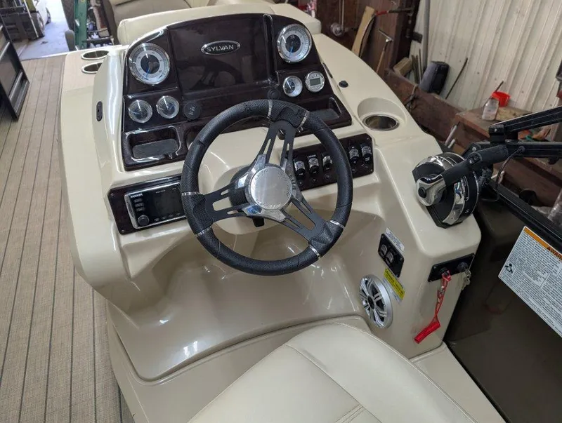 Slide: The Image of 2018 Sylvan Mirage Cruise 8524 Entertainer boat dashboard with steering wheel and controls. - 10
