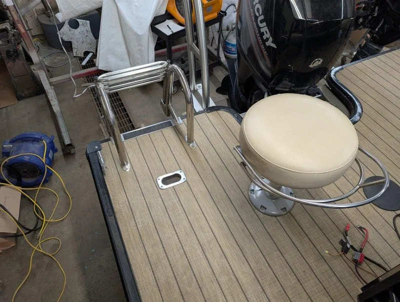 Slide: The Image of 2018 Sylvan Mirage Cruise 8524 Entertainer boat deck with seat and Mercury engine. - 11