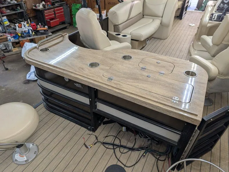 Slide: The Image of 2018 Sylvan Mirage Cruise 8524 Entertainer boat interior with bar and seating area. - 12