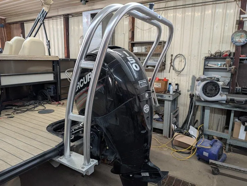 Slide: The Image of 2018 Sylvan Mirage Cruise 8524 Entertainer with Mercury 150 outboard motor in workshop. - 2