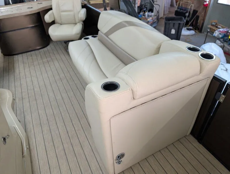 Slide: The Image of 2018 Sylvan Mirage Cruise 8524 Entertainer boat interior with beige seating and cup holders. - 6