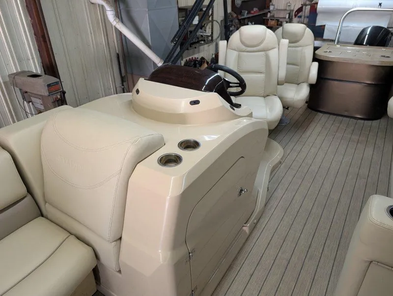 Slide: The Image of 2018 Sylvan Mirage Cruise 8524 Entertainer interior with beige seating and helm. - 7