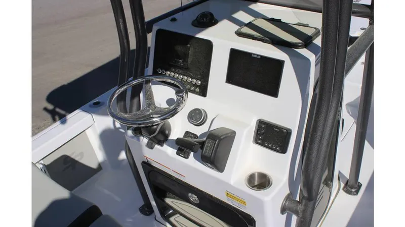 Slide: The Image of 2025 Sea Pro 230 Bay boat console with steering wheel and navigation controls. - 3