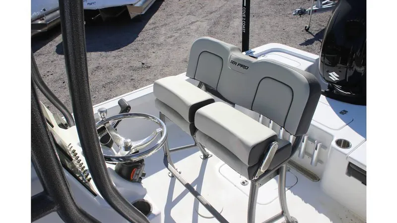 Slide: The Image of 2025 Sea Pro 230 Bay boat interior with dual seating and steering wheel. - 4