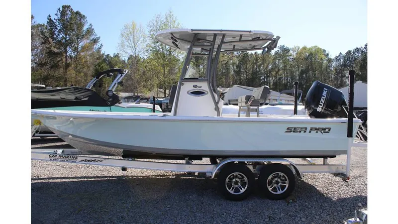 Slide: The Image of 2025 Sea Pro 230 Bay boat on trailer, side view, outdoors. - 6
