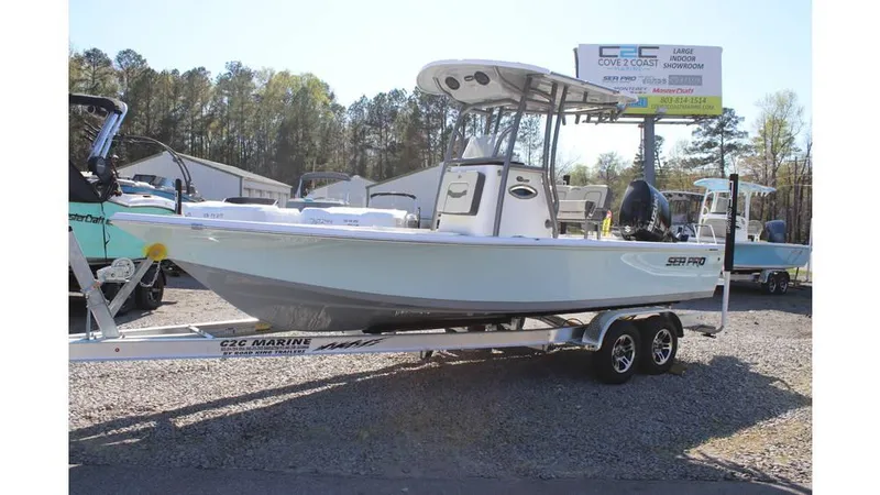 Slide: The Image of 2025 Sea Pro 230 Bay boat on trailer, displayed outdoors at a dealership. - 7