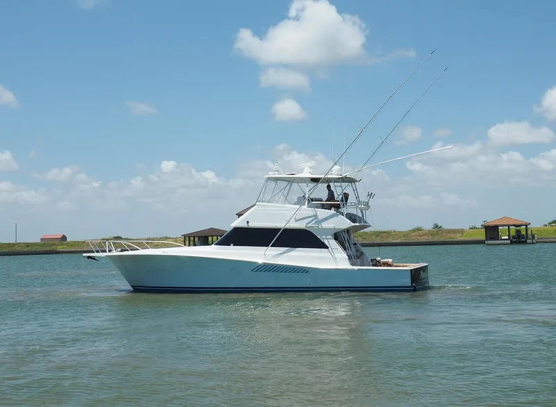 Slide: The Image of 2001 Viking Convertible boat on calm water under a blue sky. - 1