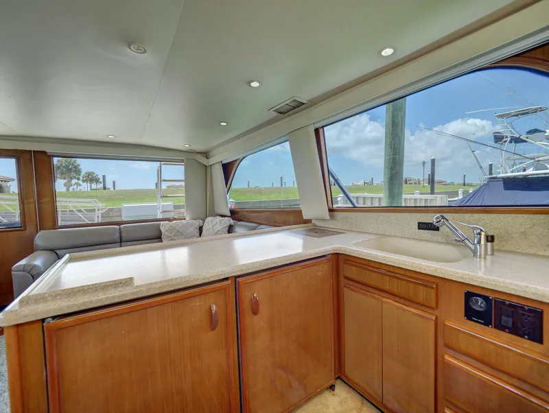 Slide: The Image of Interior of a 2001 Viking Convertible yacht with spacious kitchen and large windows. - 11