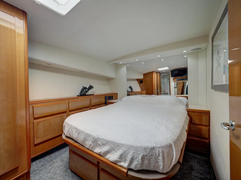 Slide: The Image of Luxurious bedroom interior of a 2001 Viking Convertible yacht with wooden cabinetry. - 14