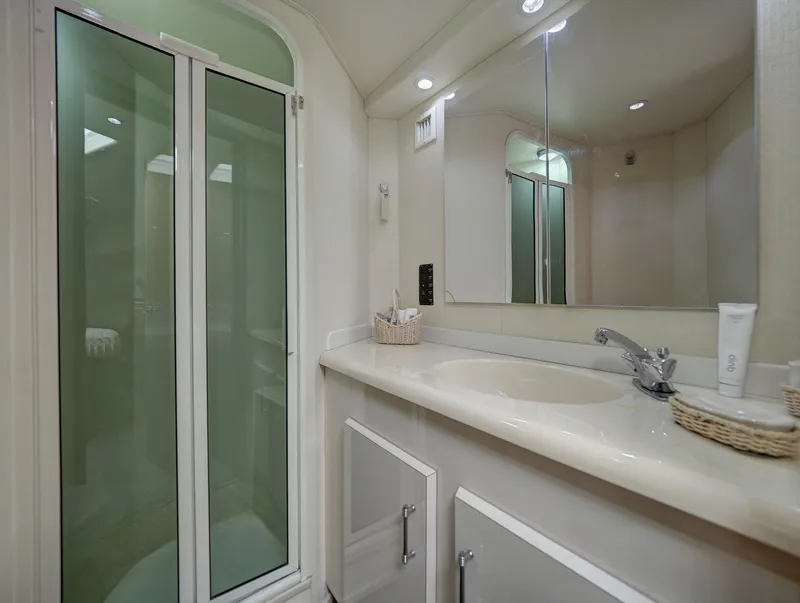 Slide: The Image of Luxurious bathroom in a 2001 Viking Convertible yacht with shower and vanity. - 17