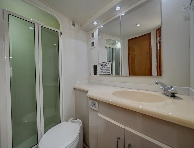 Slide: The Image of Bathroom interior of a 2001 Viking Convertible yacht with shower and vanity. - 20
