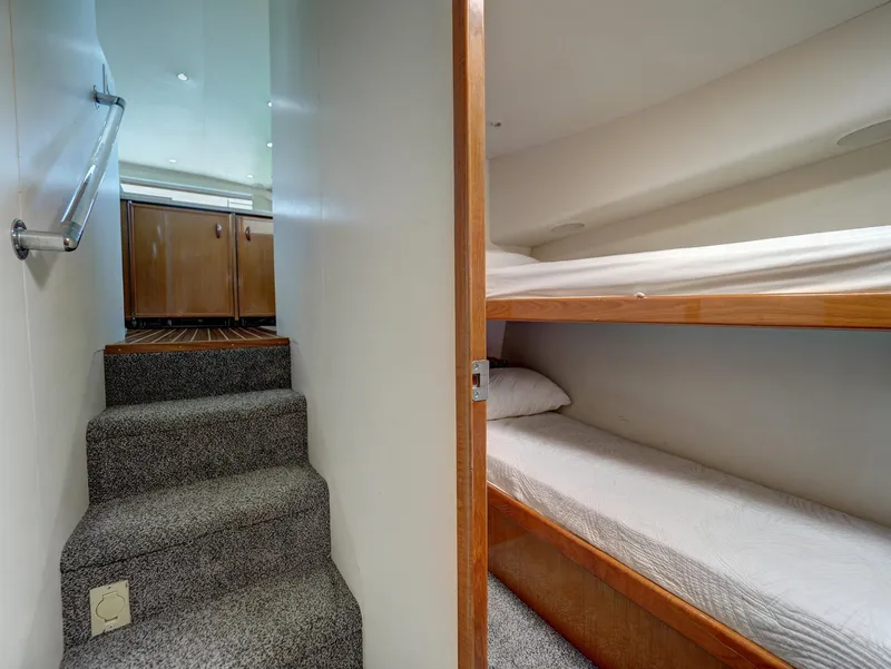 Slide: The Image of 2001 Viking Convertible yacht interior with bunk beds and carpeted stairs. - 21