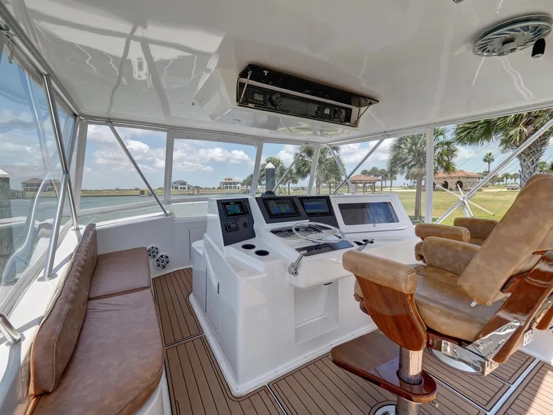 Slide: The Image of 2001 Viking Convertible yacht helm with leather seating, modern controls, and panoramic windows. - 23