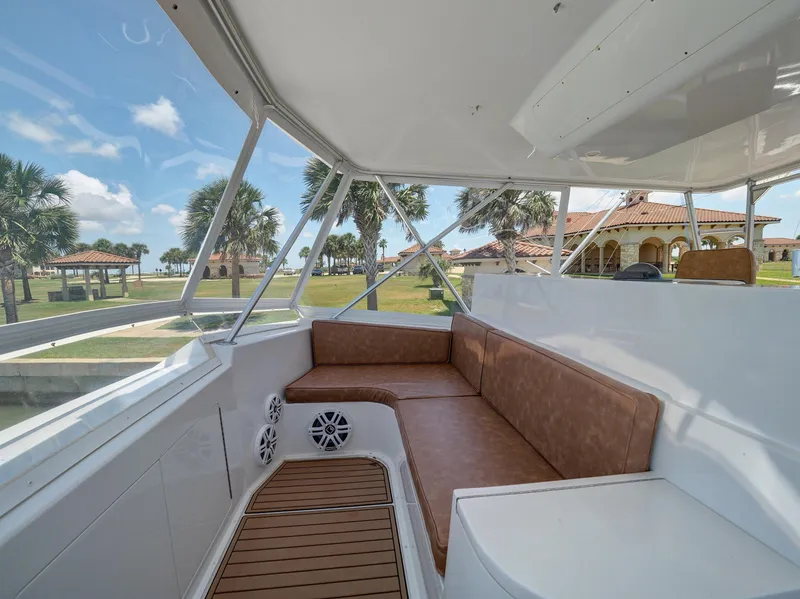 Slide: The Image of 2001 Viking Convertible boat interior with brown seating, wooden flooring, and scenic outdoor view. - 27