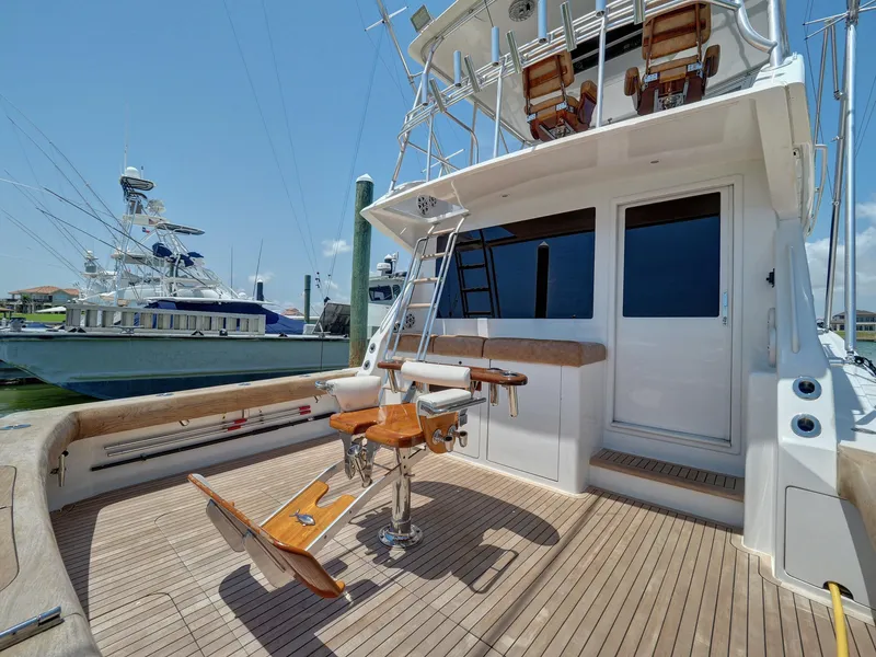 Slide: The Image of 2001 Viking Convertible yacht with spacious deck and fishing chair, docked at marina. - 32