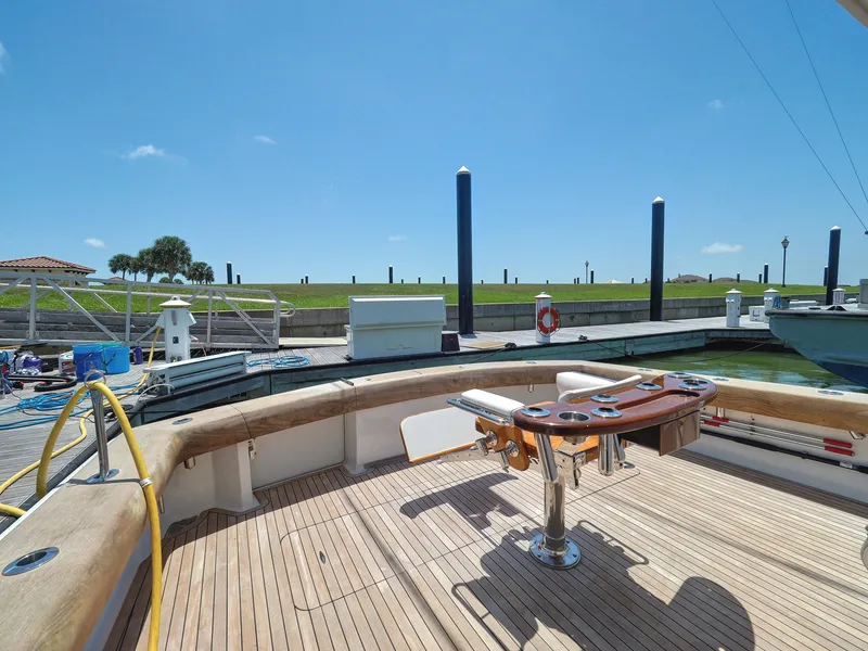 Slide: The Image of 2001 Viking Convertible yacht deck with fishing station, docked under clear blue sky. - 33