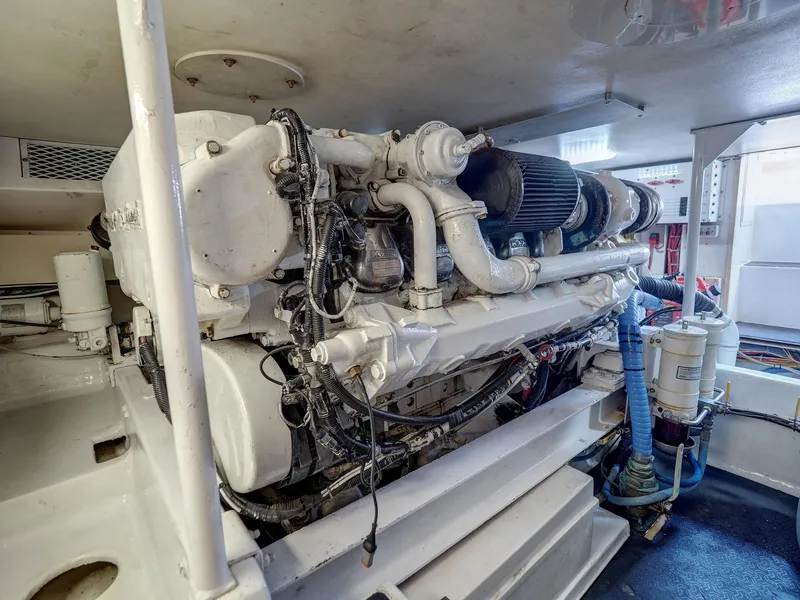 Slide: The Image of Engine room of a 2001 Viking Convertible yacht, showcasing a powerful marine engine. - 35