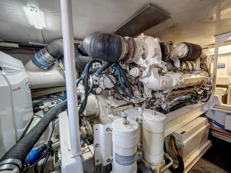 Slide: The Image of Engine room of a 2001 Viking Convertible yacht, showcasing complex machinery and components. - 38