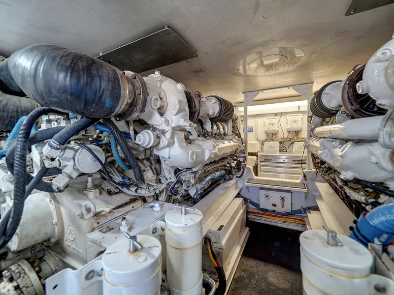 Slide: The Image of Engine room of a 2001 Viking Convertible yacht, showcasing complex machinery and components. - 39