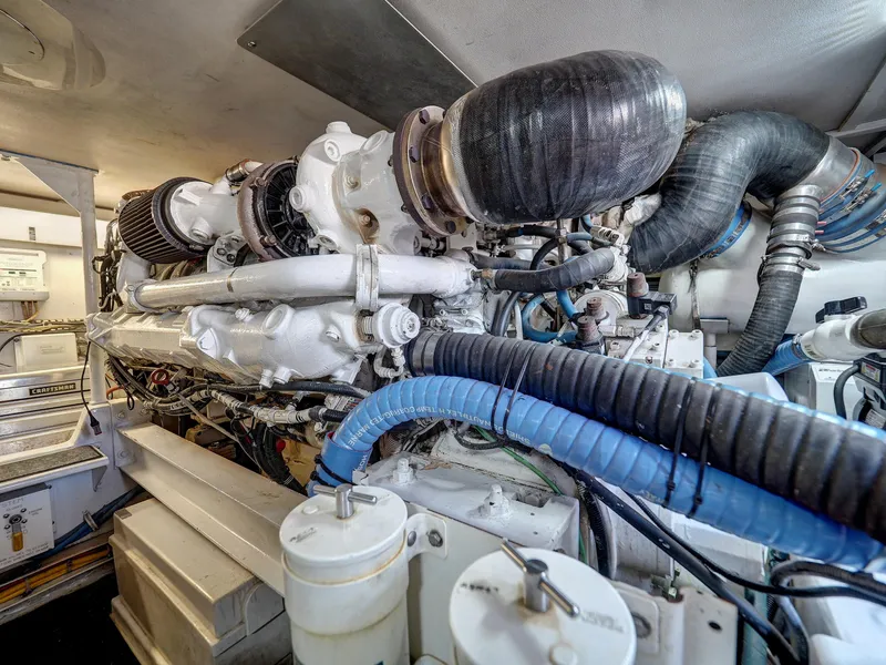 Slide: The Image of Engine room of a 2001 Viking Convertible boat, showcasing complex machinery and components. - 40