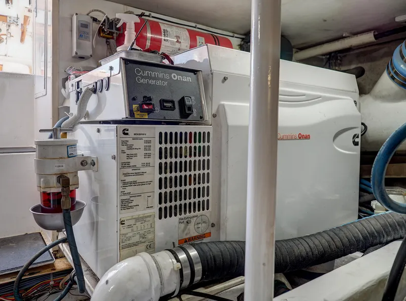 Slide: The Image of Cummins Onan generator in 2001 Viking Convertible engine room, showcasing marine equipment. - 41