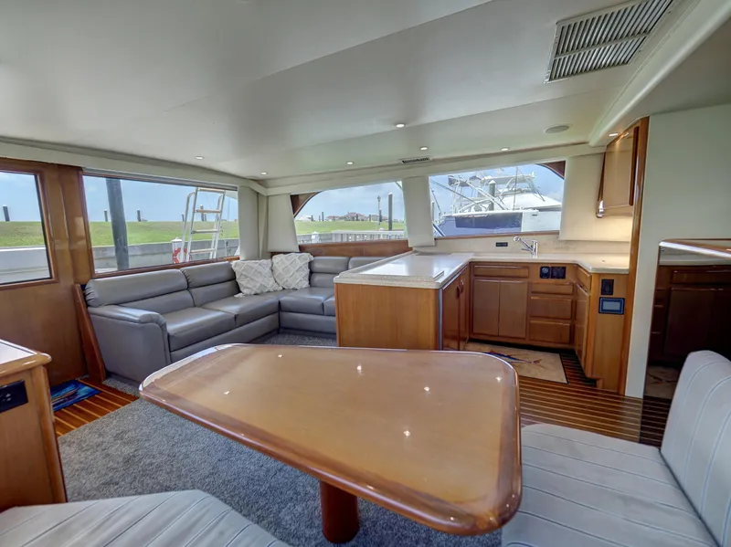 Slide: The Image of Luxurious interior of a 2001 Viking Convertible yacht with modern furnishings and spacious layout. - 7