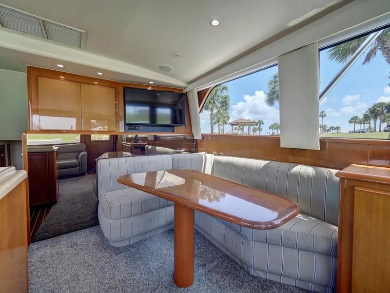 Slide: The Image of Luxurious interior of a 2001 Viking Convertible yacht with plush seating and large windows. - 8